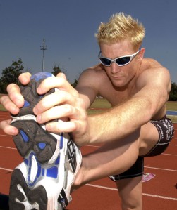Iwan Thomas one of the Silver Medal winning 4x400m Relay Squad at the last Olympics, does stretch exercises at the Great Britain Athletics Training Camp on the Gold Coast of Australia.